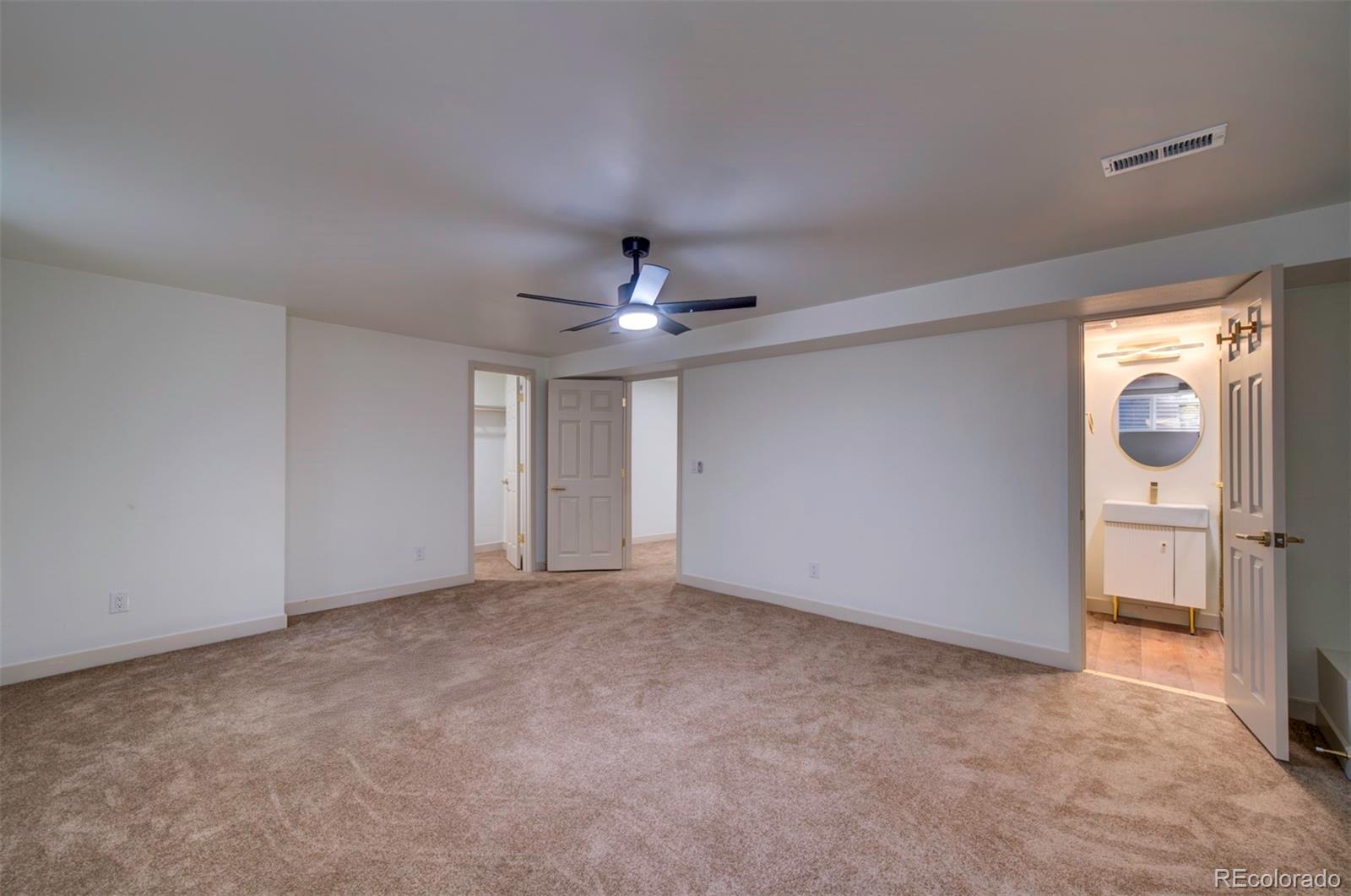 1815 South Monroe Street Denver, CO 80210 - Photo 35 of 37 an empty room with chandelier fan and windows