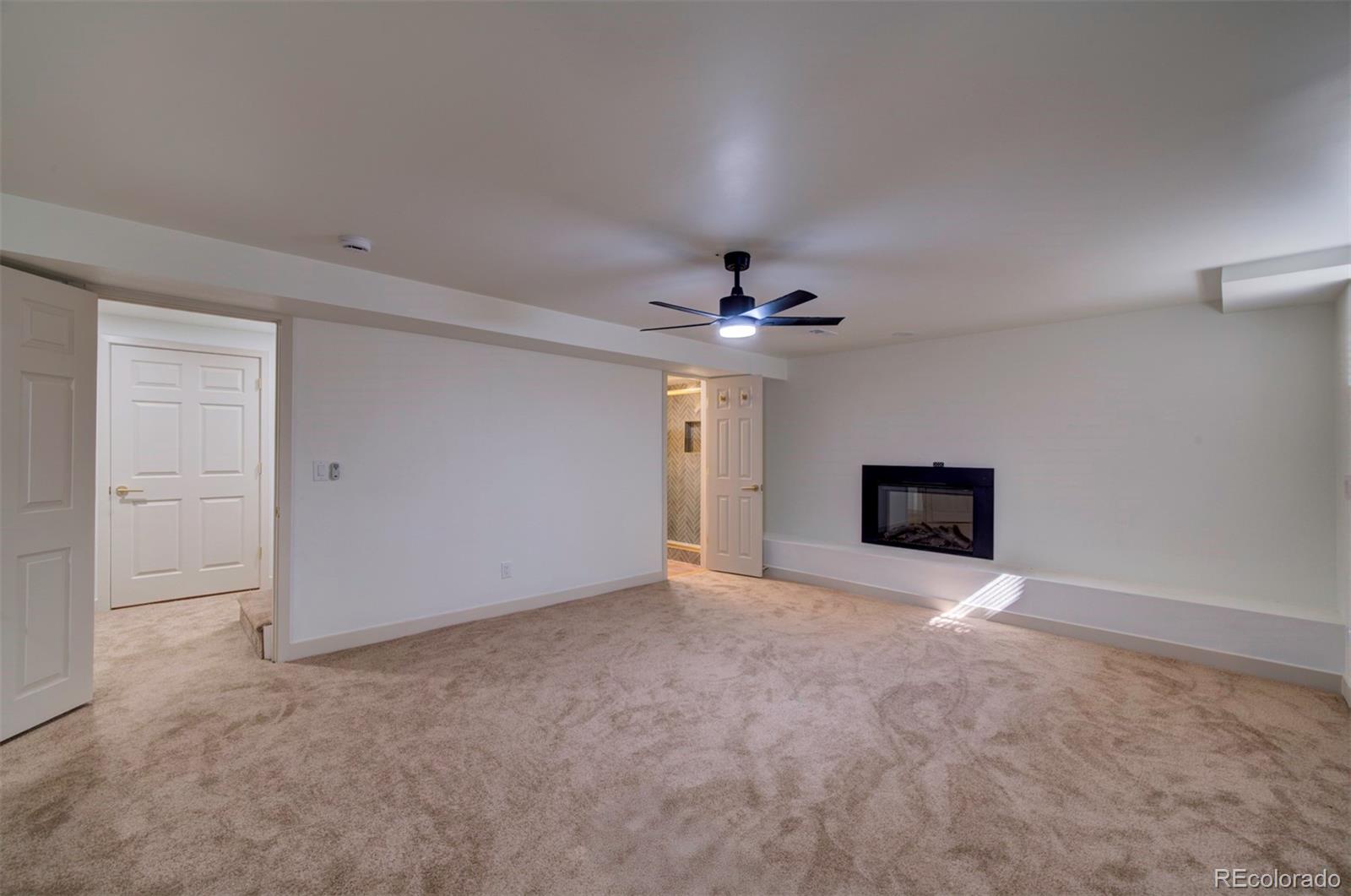 1815 South Monroe Street Denver, CO 80210 - Photo 36 of 37 en empty room with windows and fireplace