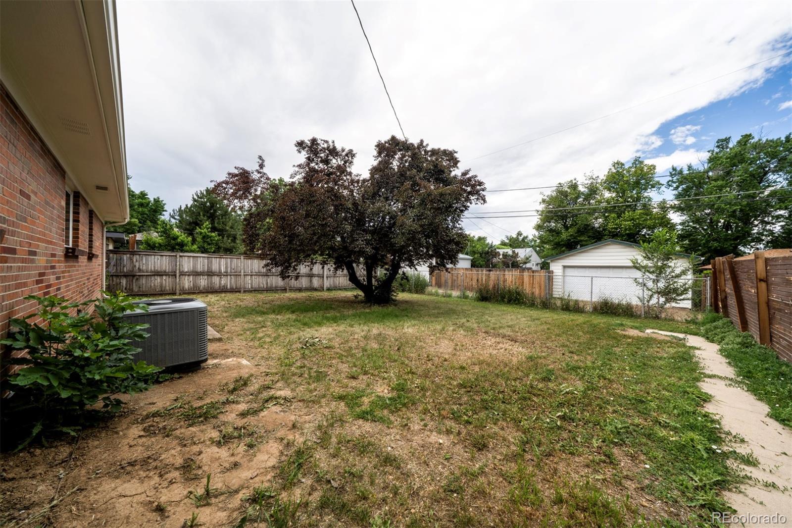 1815 South Monroe Street Denver, CO 80210 - Photo 4 of 37 a backyard of a house with lots of green space