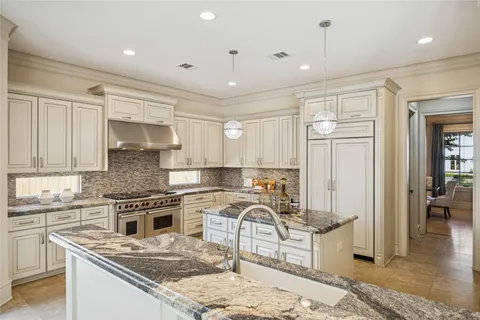 a view of kitchen with granite countertop cabinets next to a window