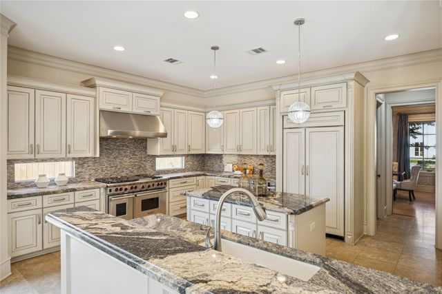 a view of kitchen with granite countertop cabinets next to a window