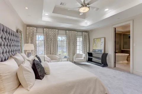 a spacious bathroom with a tub sink and a mirror