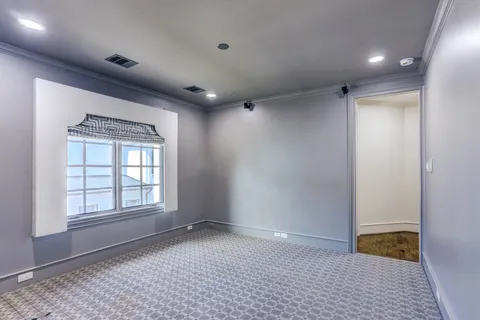 an empty room with windows and closet