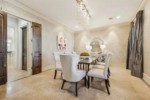 a view of a dining room with furniture and a chandelier