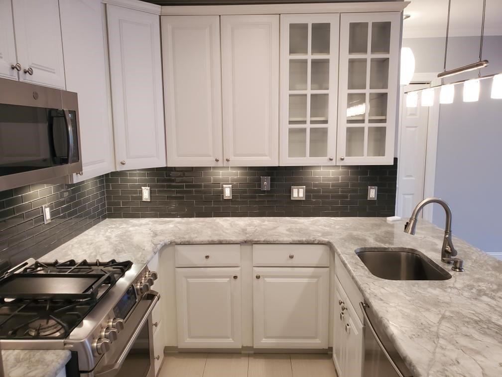 82 Clinton Street, Unit 5E Hoboken, NJ 07030 - Photo 3 of 7 a kitchen with granite countertop a stove sink and cabinets