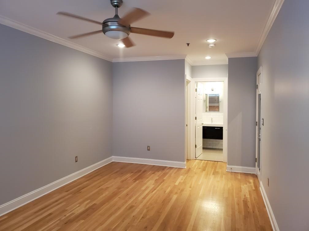 82 Clinton Street, Unit 5E Hoboken, NJ 07030 - Photo 5 of 7 a view of empty room with wooden floor and fan