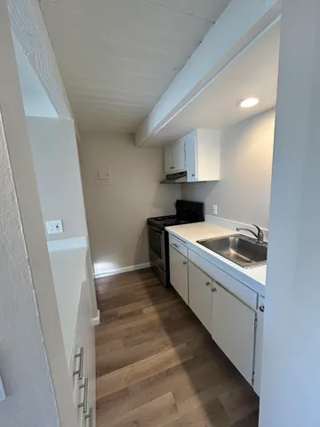 a view of a kitchen with a sink cabinets and a window