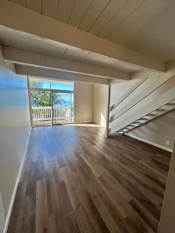 a view of an empty room and wooden floor