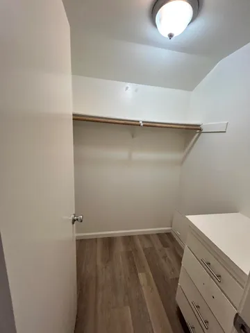 a view of a room with wooden floor