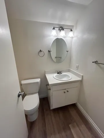 a bathroom with a toilet sink and mirror