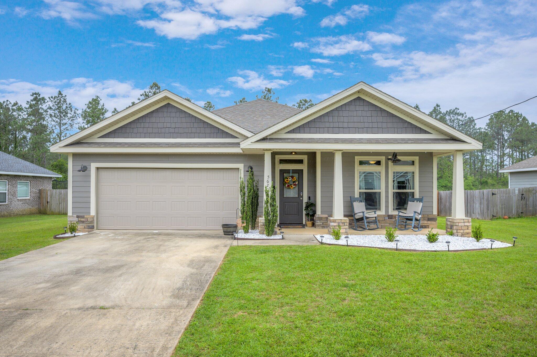 5620 Price Plantation Road Baker, FL 32531 - Photo 1 of 37 a front view of a house with a yard and garage