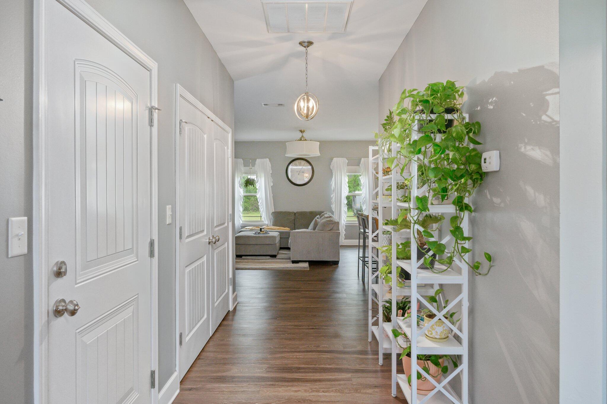 5620 Price Plantation Road Baker, FL 32531 - Photo 12 of 37 a hall way with furniture and a chandelier