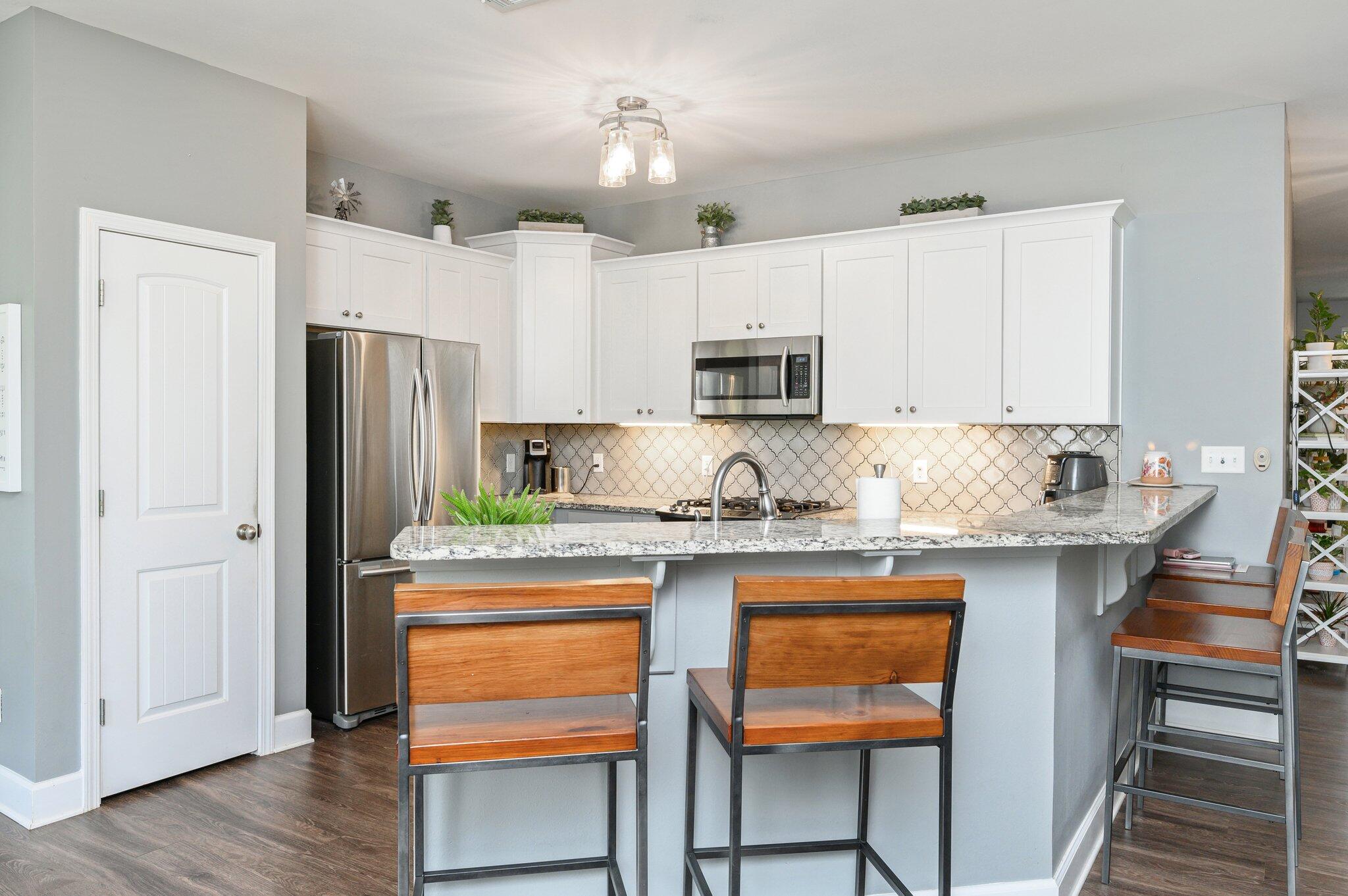 5620 Price Plantation Road Baker, FL 32531 - Photo 17 of 37 a kitchen with stainless steel appliances granite countertop a refrigerator and a stove top oven