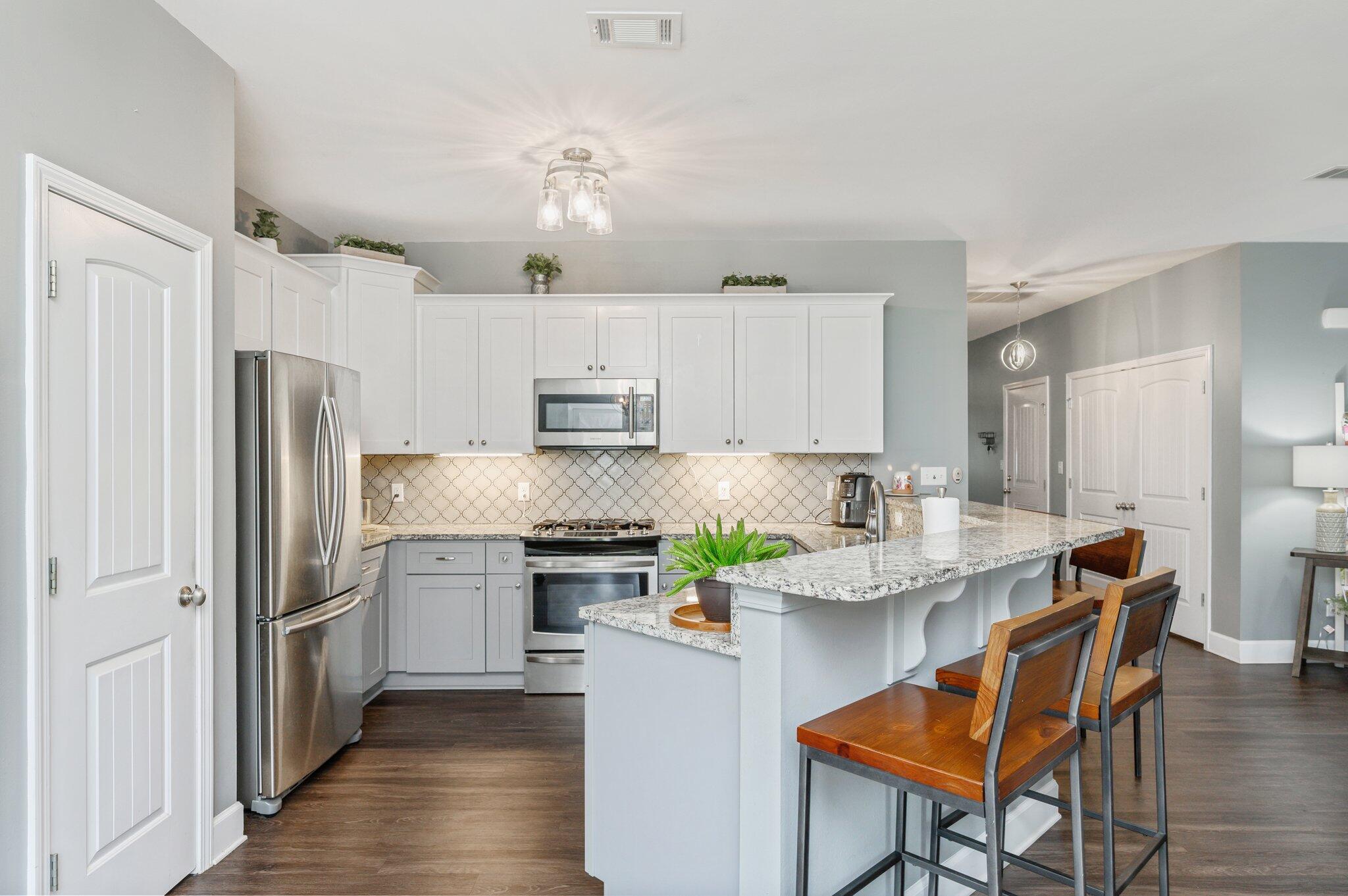5620 Price Plantation Road Baker, FL 32531 - Photo 19 of 37 a kitchen with stainless steel appliances granite countertop a white cabinets and a refrigerator