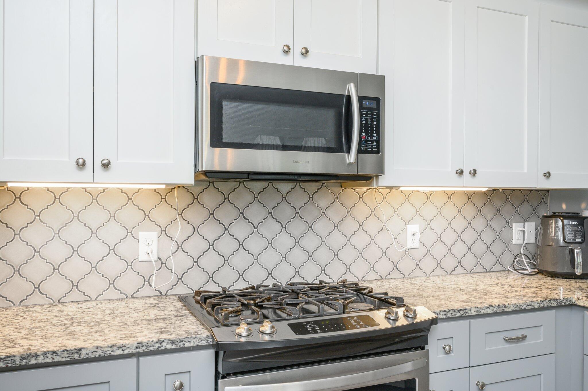5620 Price Plantation Road Baker, FL 32531 - Photo 20 of 37 a kitchen with granite countertop white cabinets and a stove