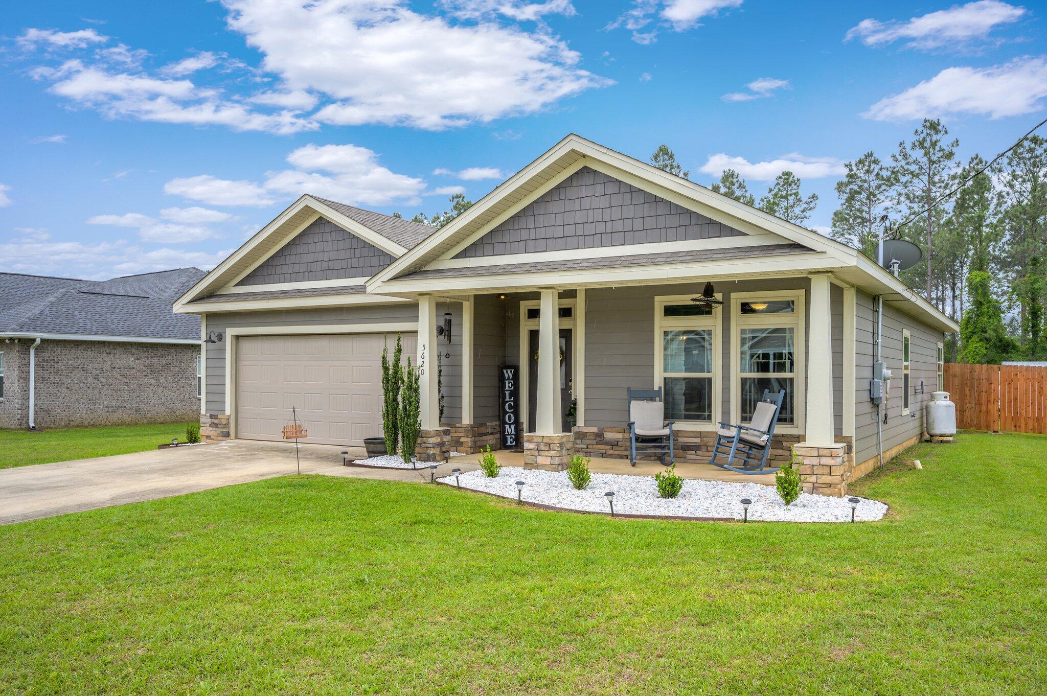 5620 Price Plantation Road Baker, FL 32531 - Photo 2 of 37 a front view of house with yard and green space