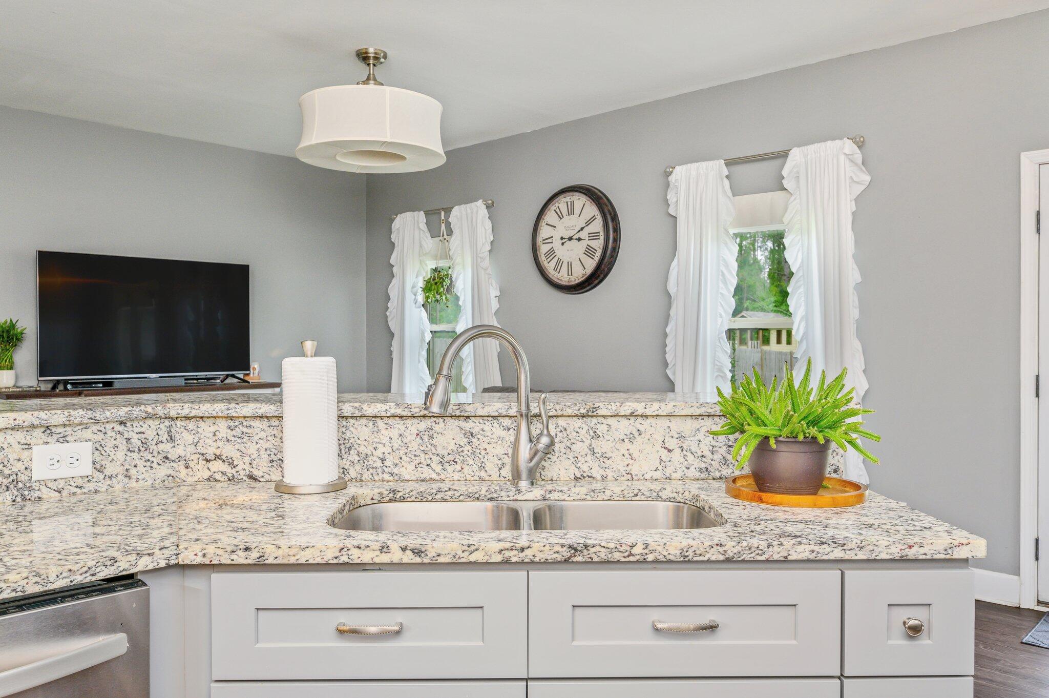 5620 Price Plantation Road Baker, FL 32531 - Photo 21 of 37 a kitchen with granite countertop a sink a stove and a mirror