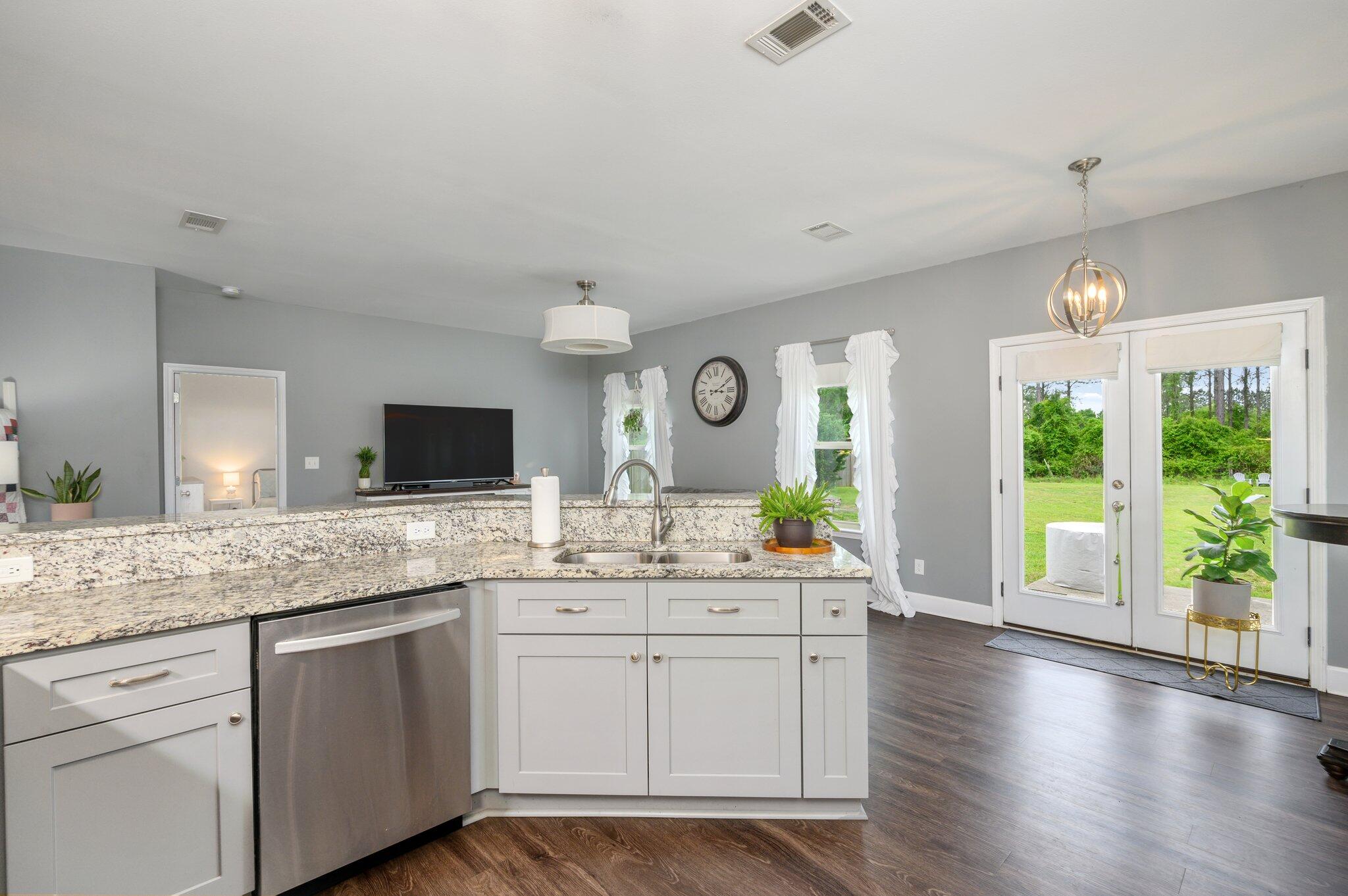 5620 Price Plantation Road Baker, FL 32531 - Photo 22 of 37 a kitchen with a sink stove and cabinets