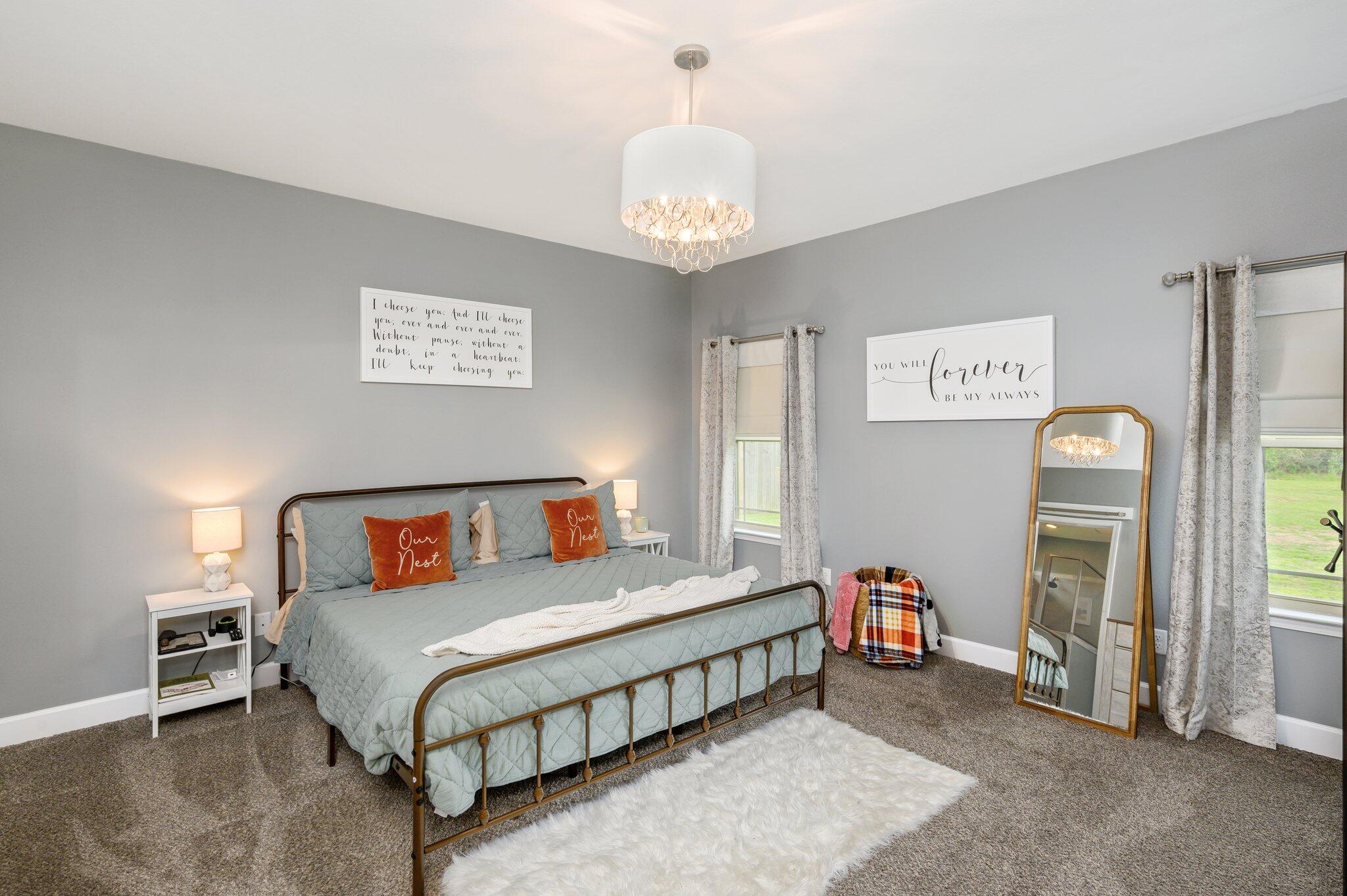 5620 Price Plantation Road Baker, FL 32531 - Photo 24 of 37 a bedroom with a bed and a chandelier