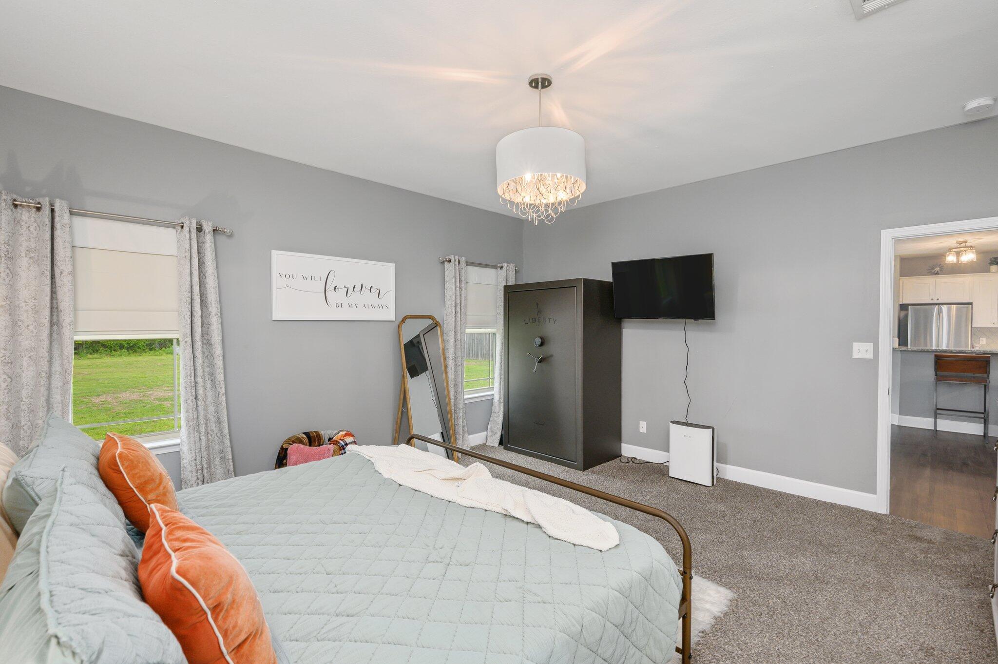 5620 Price Plantation Road Baker, FL 32531 - Photo 25 of 37 a bedroom with a bed and a flat screen tv