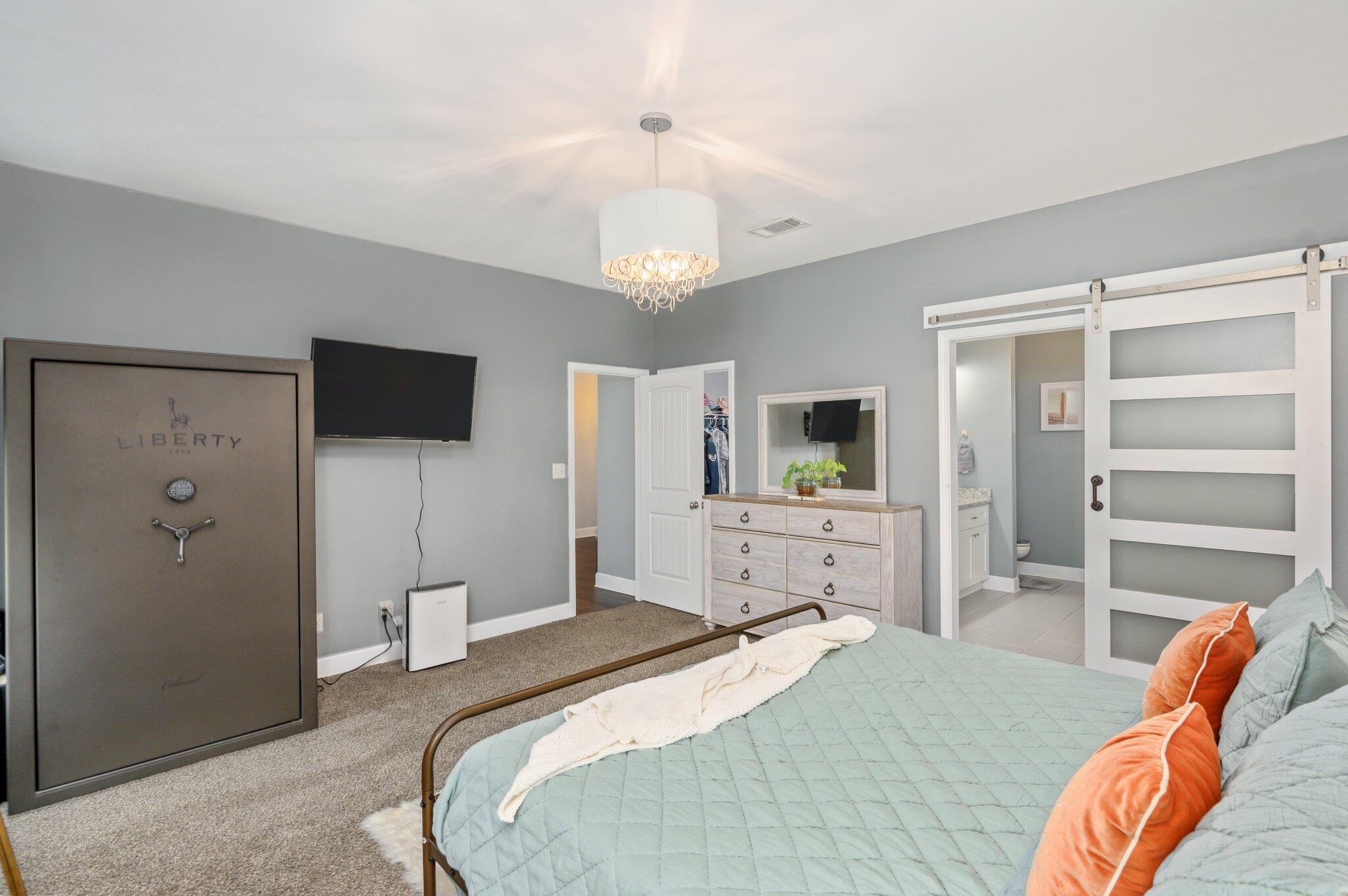 5620 Price Plantation Road Baker, FL 32531 - Photo 26 of 37 a bedroom with a bed and a flat screen tv