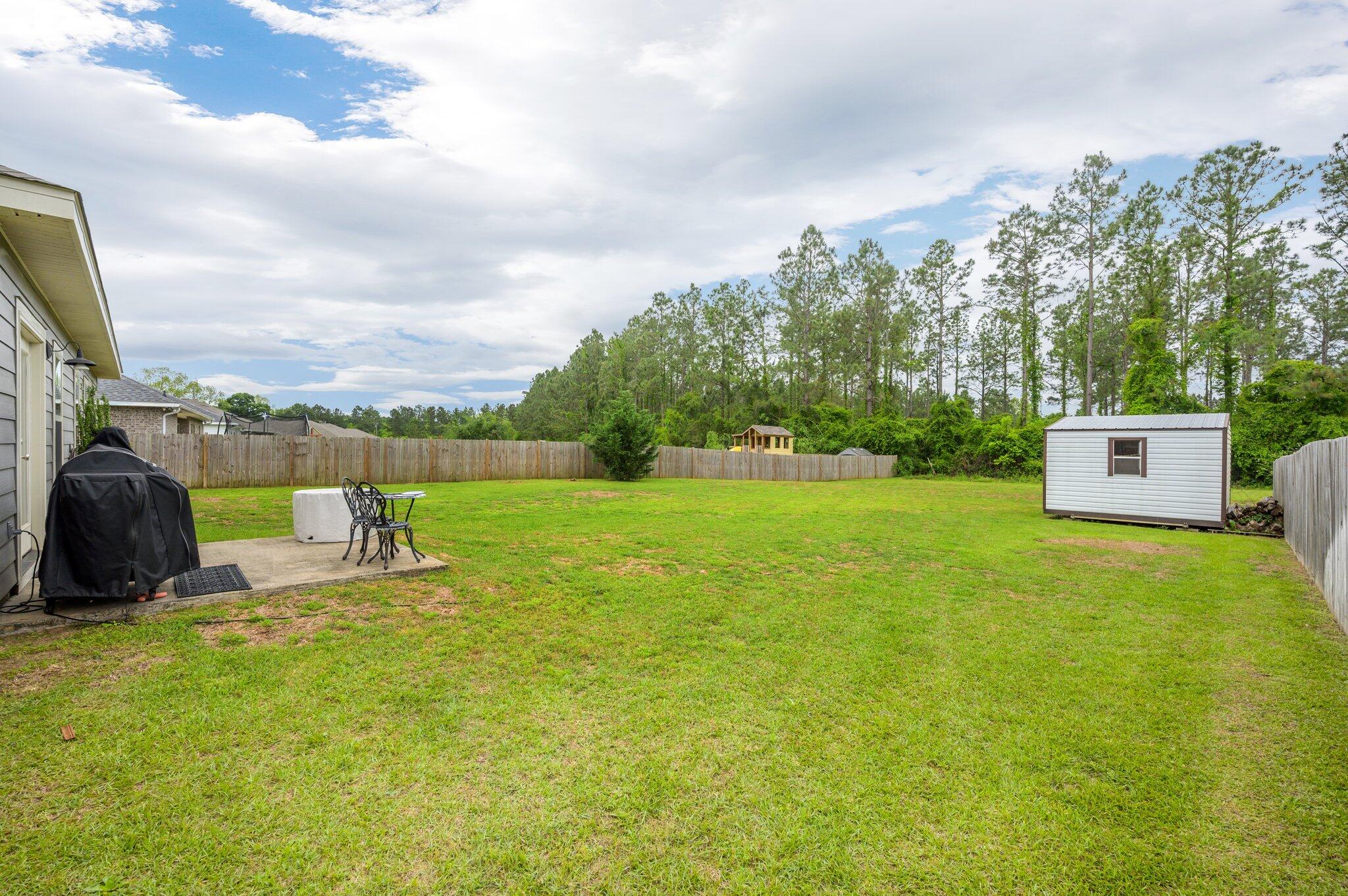 5620 Price Plantation Road Baker, FL 32531 - Photo 33 of 37 a view of a garden with an outdoor space