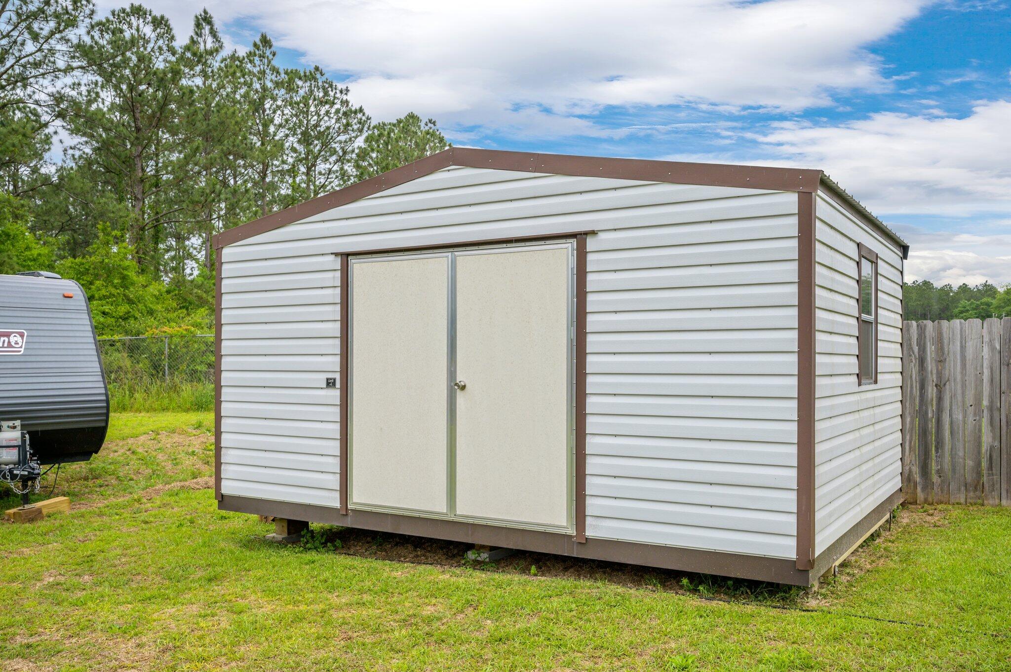 5620 Price Plantation Road Baker, FL 32531 - Photo 34 of 37 a view of a small house with a yard