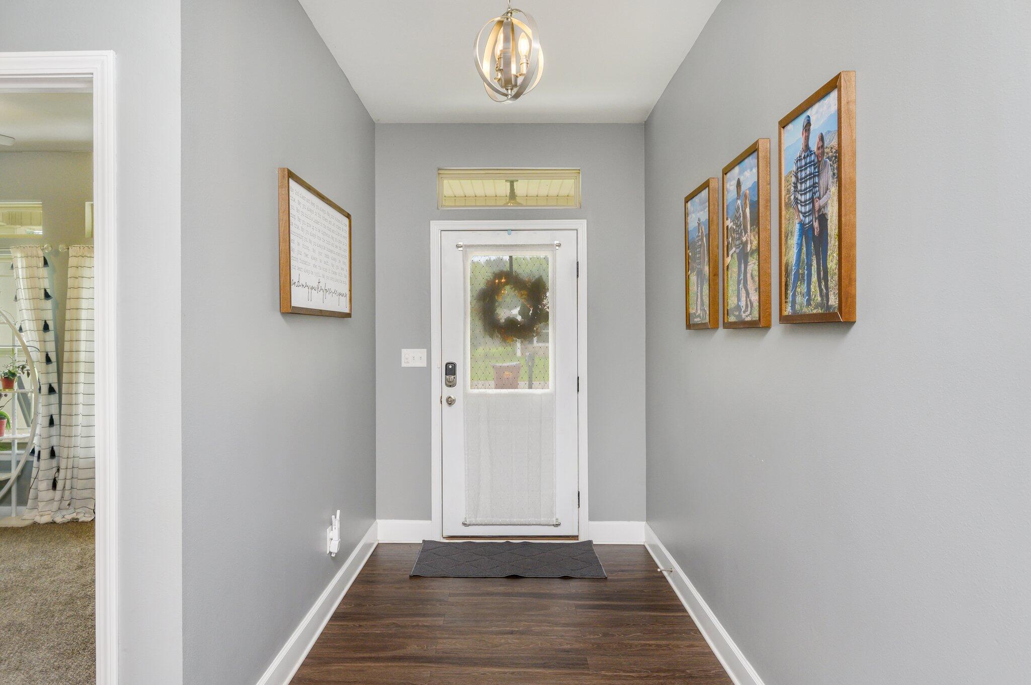 5620 Price Plantation Road Baker, FL 32531 - Photo 5 of 37 a view of a hallway with entryway wooden floor and front door