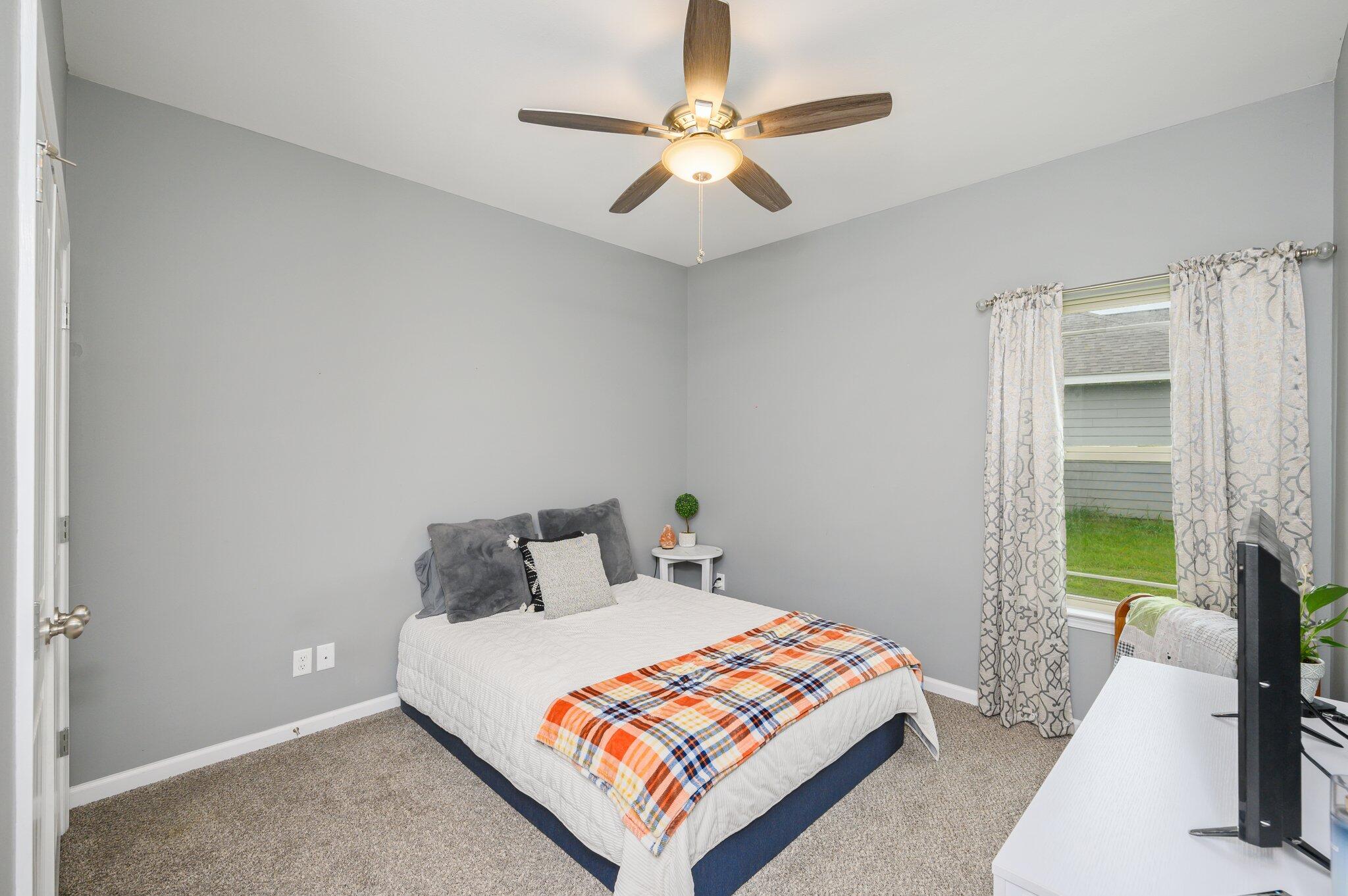 5620 Price Plantation Road Baker, FL 32531 - Photo 8 of 37 a bedroom with a bed and a chandelier