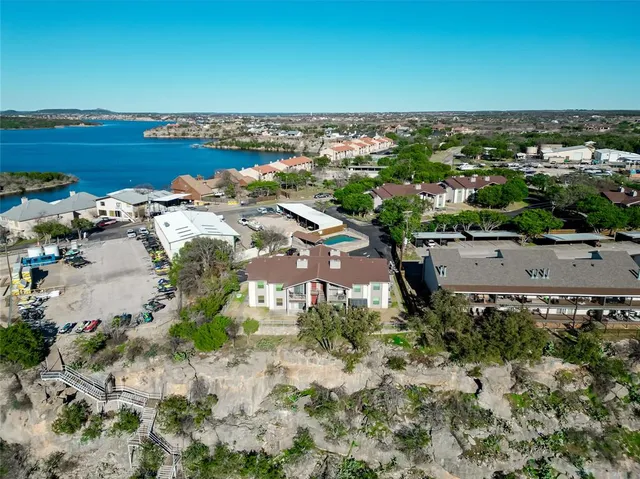 an aerial view of a house with a yard swimming pool and outdoor seating