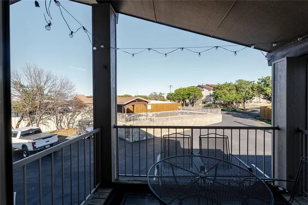 a view of a balcony with yard