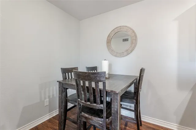 a view of a dining room with furniture and a mirror
