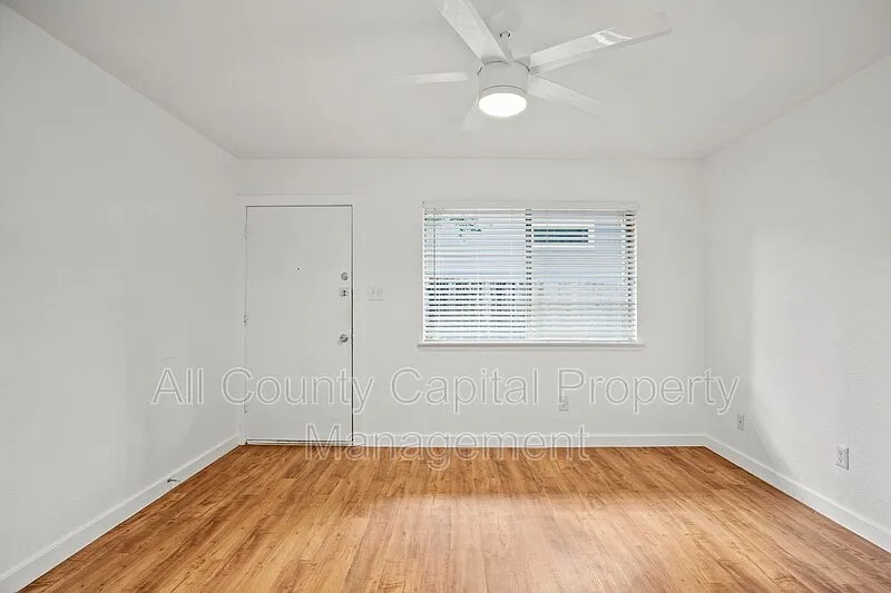 404 West 35th Street, Unit 101 Austin, TX 78705 - Photo 2 of 10 a view of an empty room with wooden floor and a window