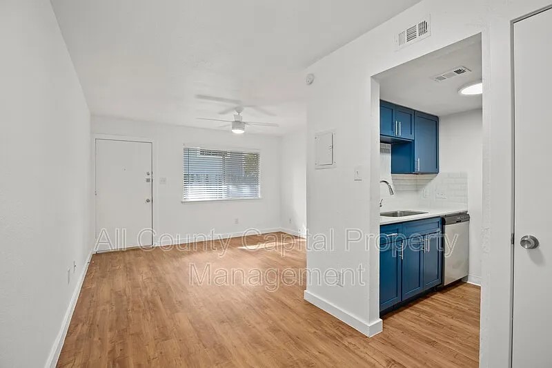 404 West 35th Street, Unit 101 Austin, TX 78705 - Photo 4 of 10 a view of a kitchen cabinets and wooden floor