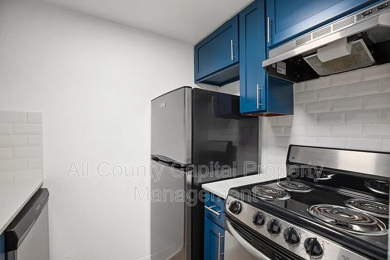 404 West 35th Street, Unit 101 Austin, TX 78705 - Photo 5 of 10 a stove top oven sitting inside of a kitchen