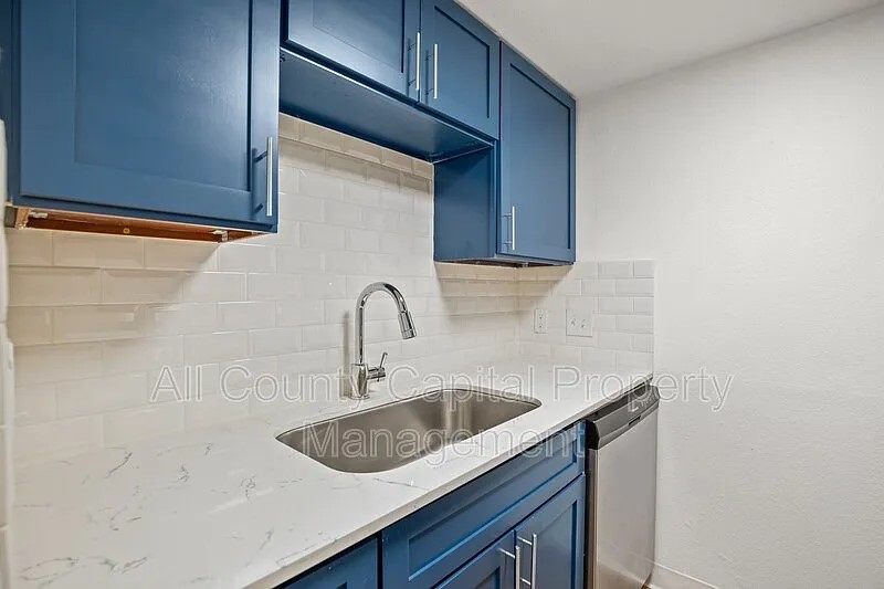 404 West 35th Street, Unit 101 Austin, TX 78705 - Photo 6 of 10 a kitchen with a sink and cabinets