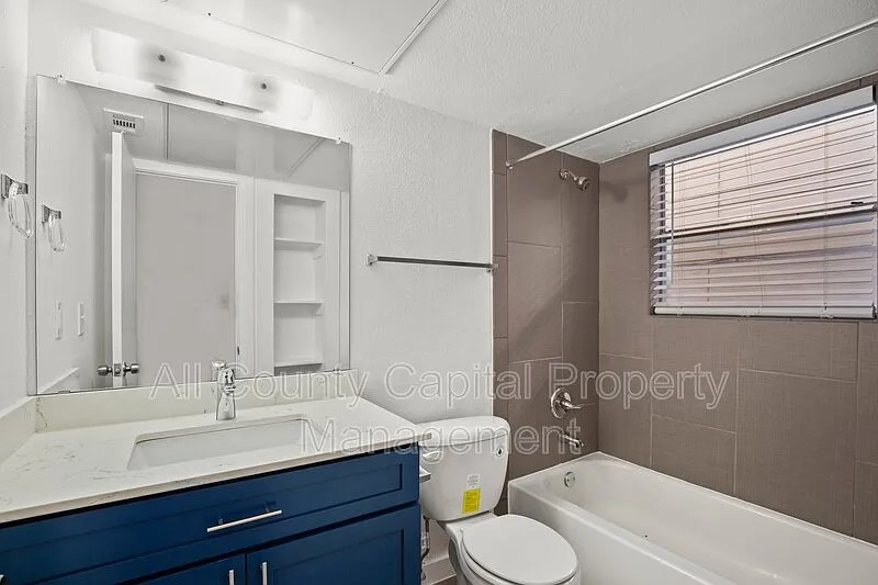 404 West 35th Street, Unit 101 Austin, TX 78705 - Photo 8 of 10 a bathroom with a sink toilet vanity and shower