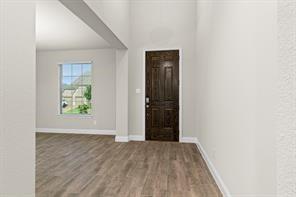 2808 Inn Kitchen Way McKinney, TX 75071 - Photo 2 of 22 Spacious living area featuring high ceilings, wood-finish flooring, and recessed lighting