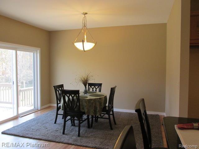 9094 Robb Road Fowlerville, MI 48836 - Photo 17 of 32 DINING ROOM W/HARDWOOD FLOOR & NEW DOORWALL TO 13 X 41' DECK