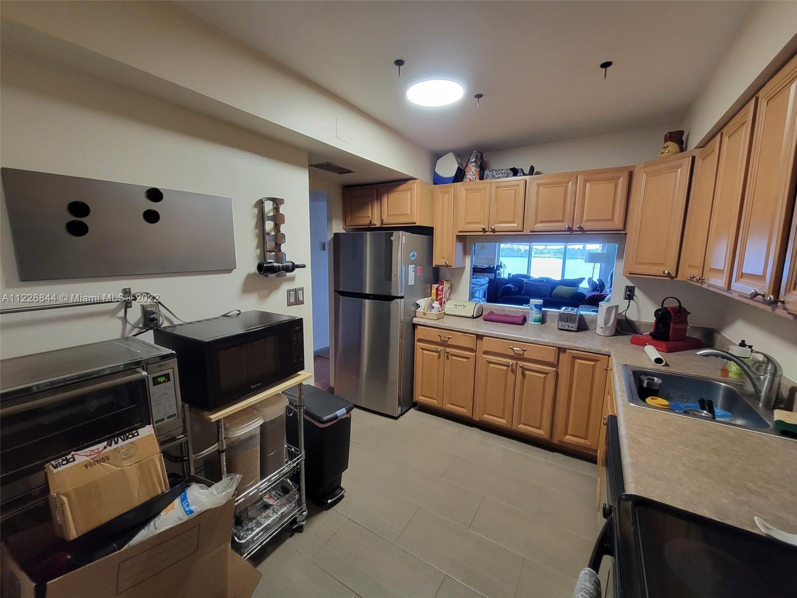 a kitchen with a refrigerator cabinets and a table