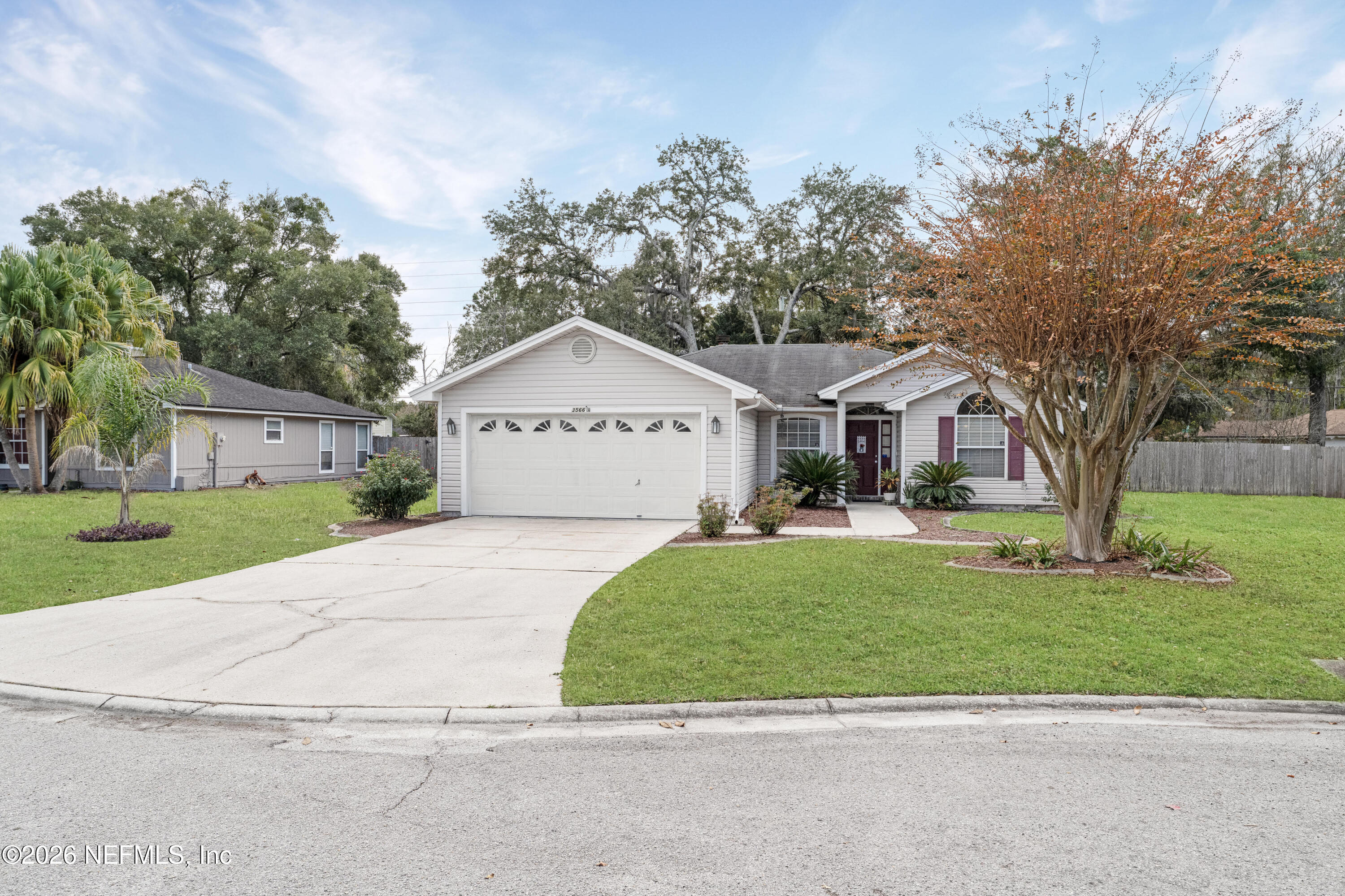 3566 Pond Ridge Court West Jacksonville, FL 32223 - Photo 2 of 17 a front view of a house with a yard and garage