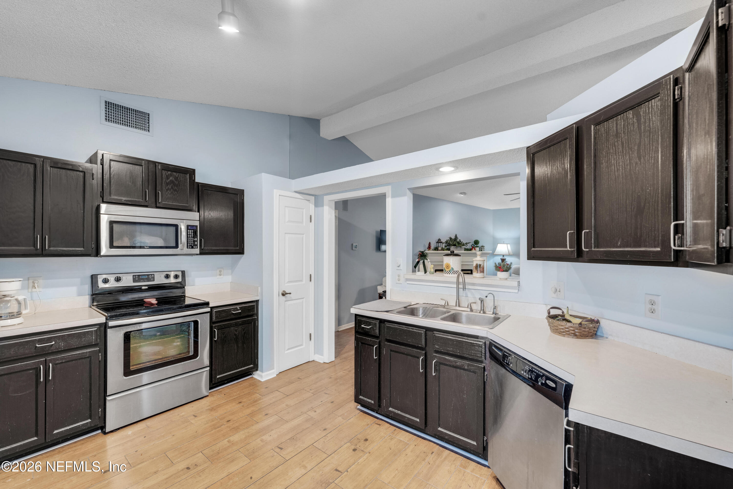 3566 Pond Ridge Court West Jacksonville, FL 32223 - Photo 7 of 17 a kitchen with kitchen island granite countertop stainless steel appliances and sink