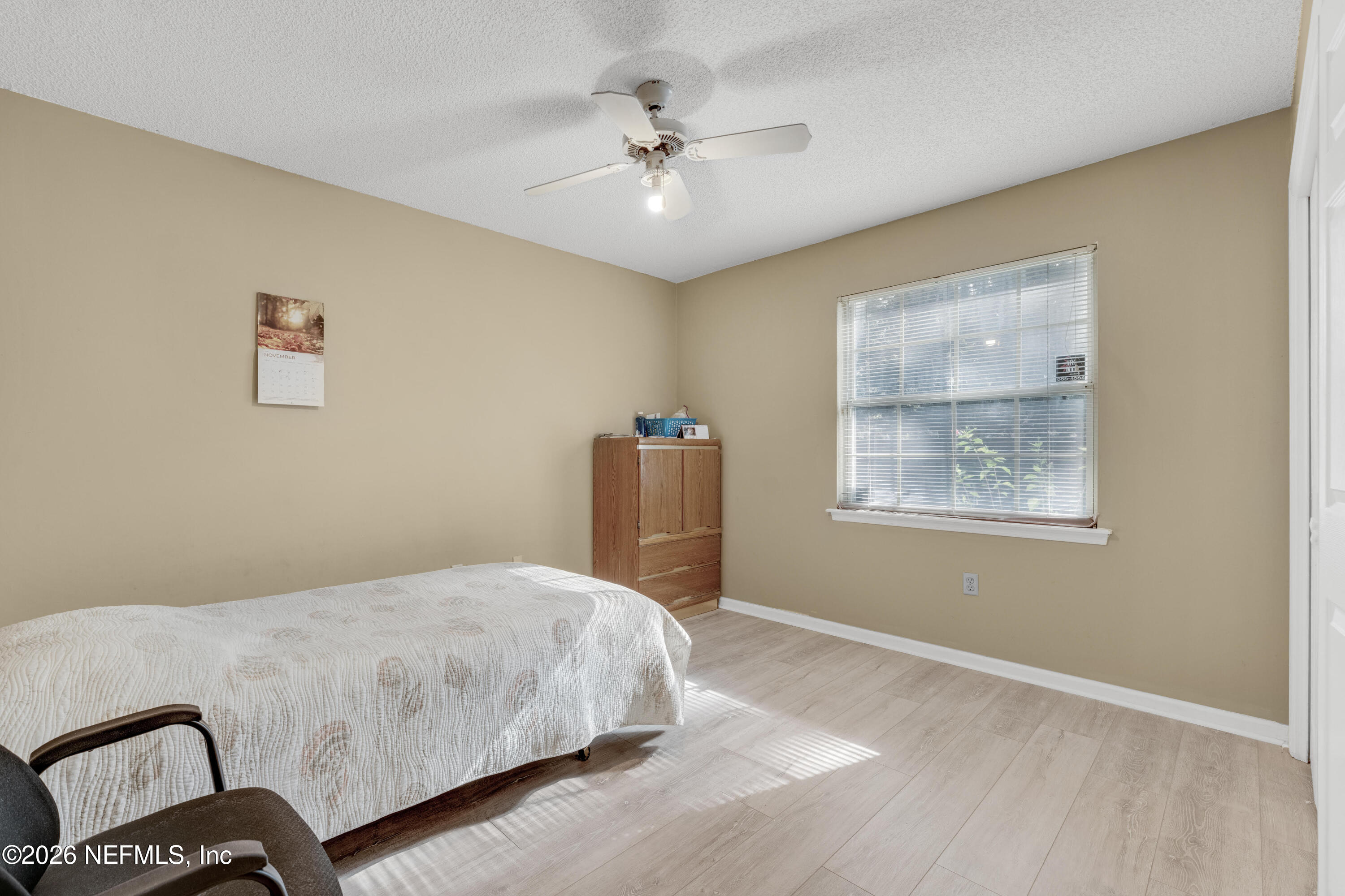 3566 Pond Ridge Court West Jacksonville, FL 32223 - Photo 10 of 17 a bedroom with a bed and a chandelier