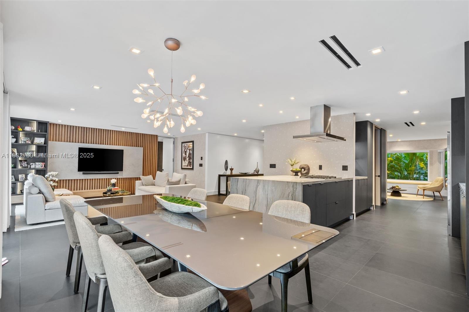 4800 Bay Point Road Miami, FL 33137 - Photo 26 of 74 a view of a dining room with furniture and a flat screen tv