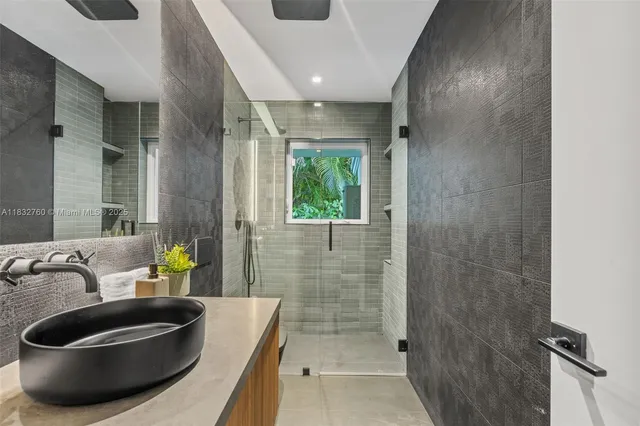a view of a patio with a table and chairs under an umbrella