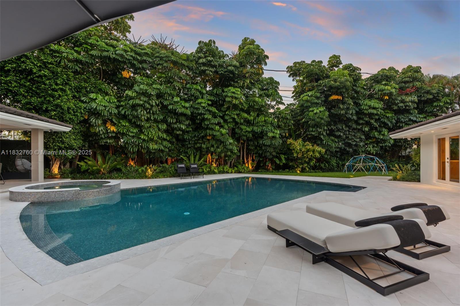 4800 Bay Point Road Miami, FL 33137 - Photo 58 of 74 a swimming pool with outdoor seating and garden