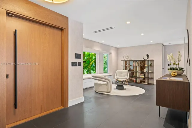 a living room with furniture flat screen tv and a large window
