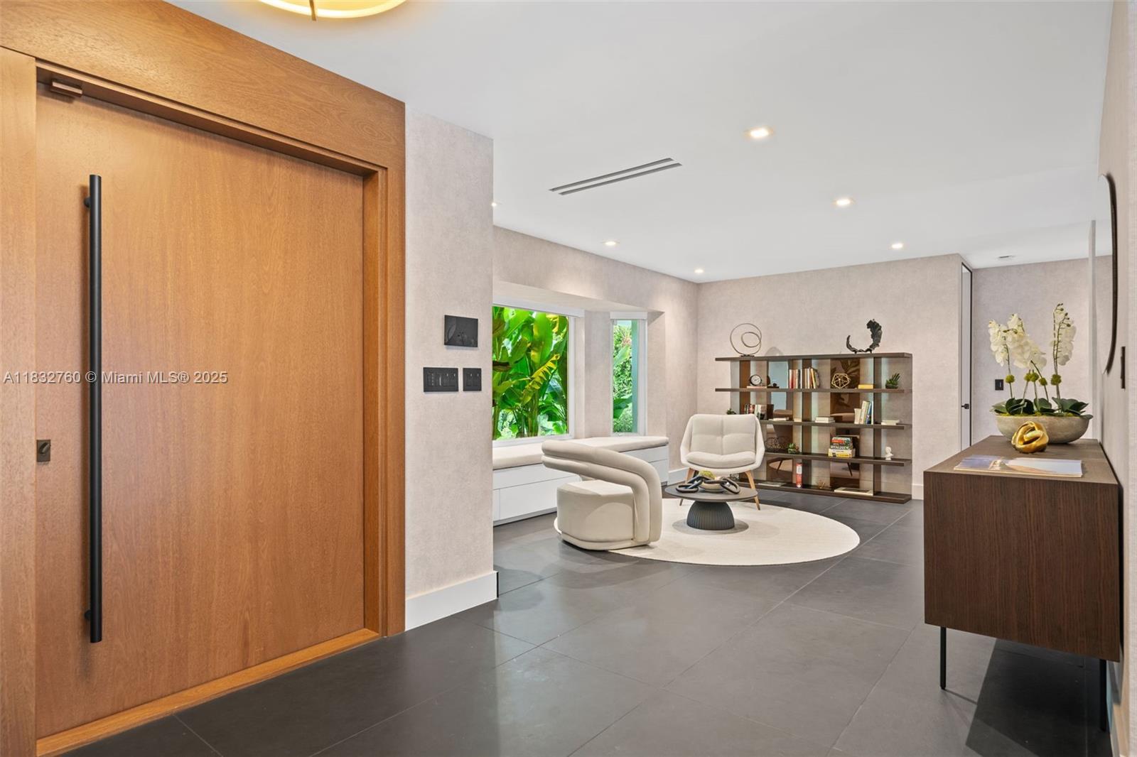 4800 Bay Point Road Miami, FL 33137 - Photo 6 of 74 a living room with couches and a dining table with kitchen view