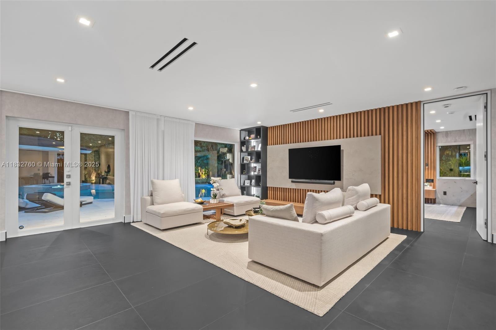 4800 Bay Point Road Miami, FL 33137 - Photo 62 of 74 a living room with fireplace furniture and a flat screen tv