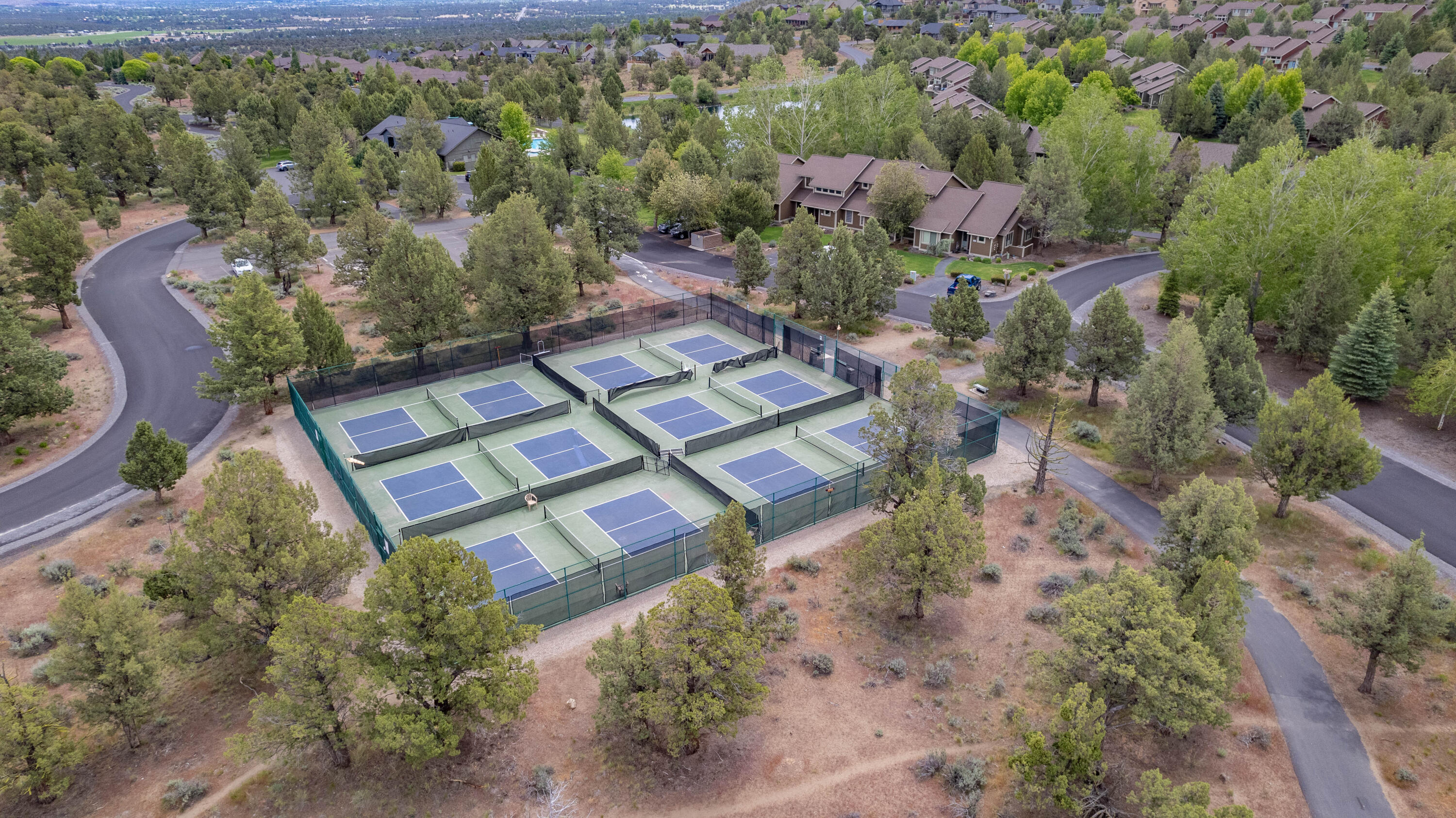 9009 Merlin Drive Redmond, OR 97756 - Photo 87 of 98 an aerial view of a house with a yard and lake view